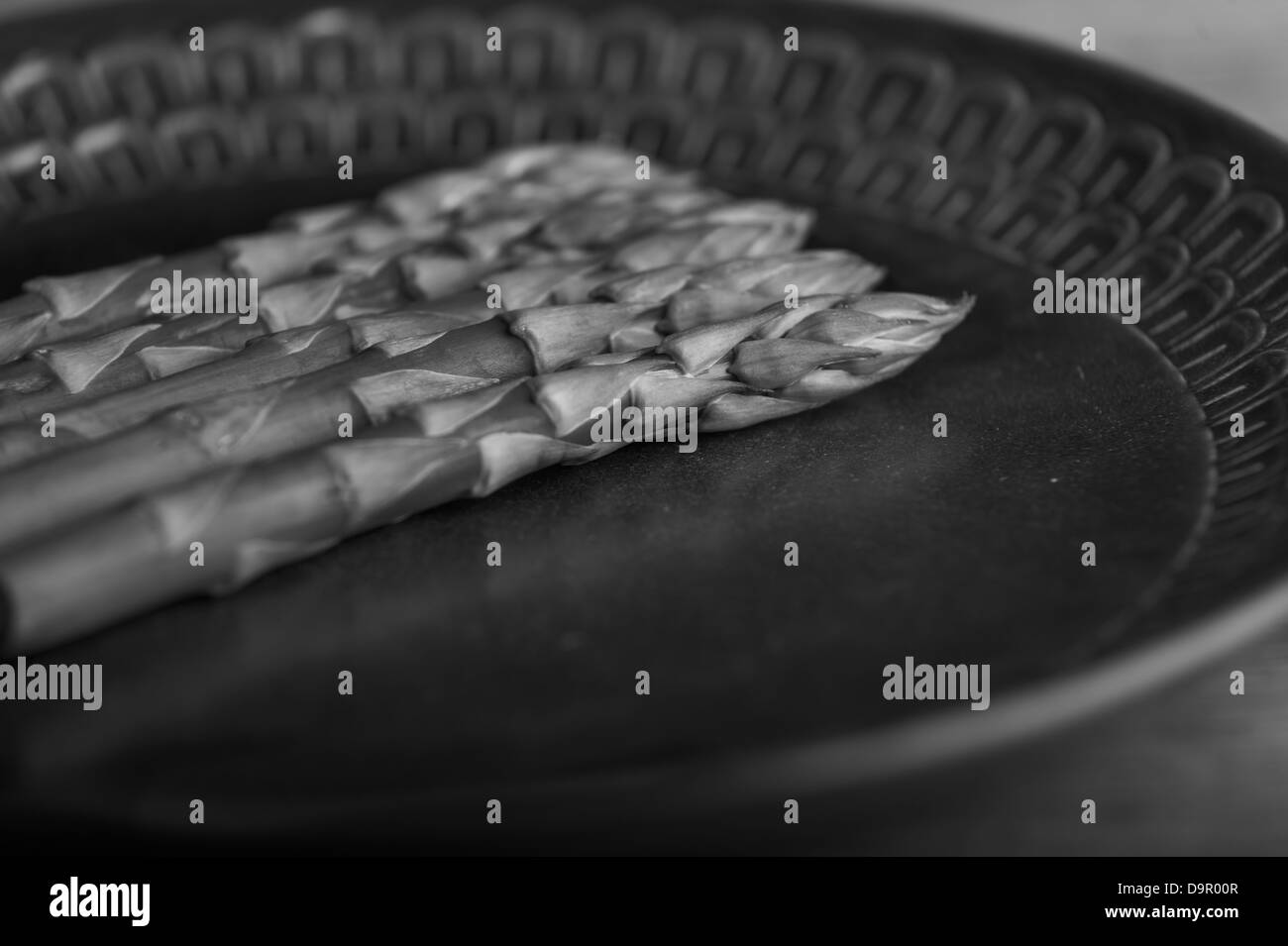 Spears of asparagus on deco wedgewood plate Stock Photo