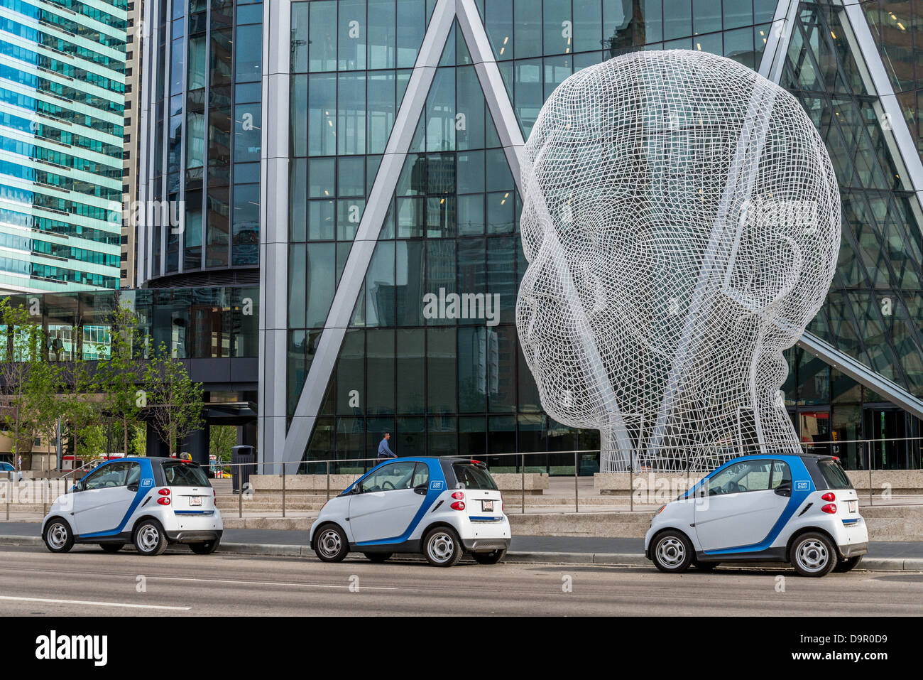 Car2Go rental cars and sculpture titled "Wonderland" by Jaume Plensa