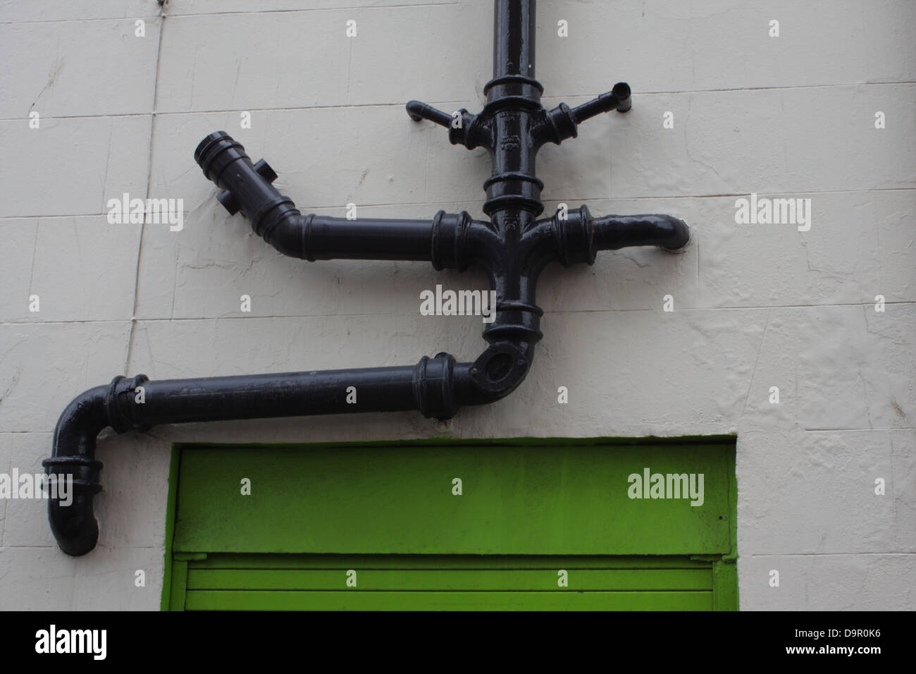 Drainpipes. multiple drainpipes on the outside of a building. Stock Photo