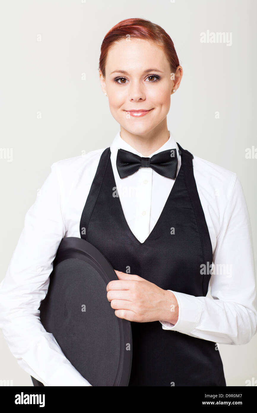 pretty young waitress with empty tray on white Stock Photo