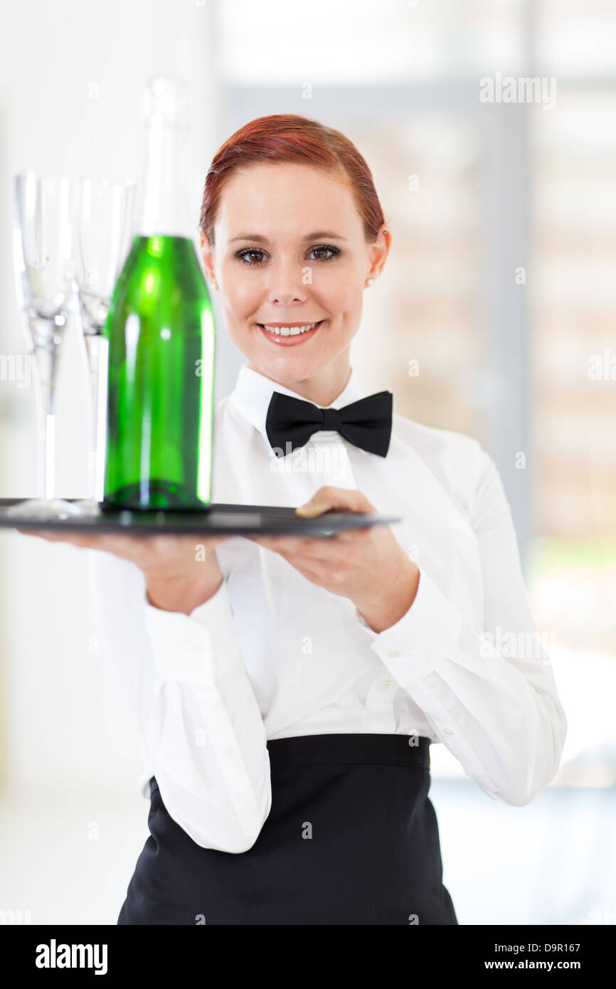 young waitress holding a tray with champagne and glasses Stock Photo