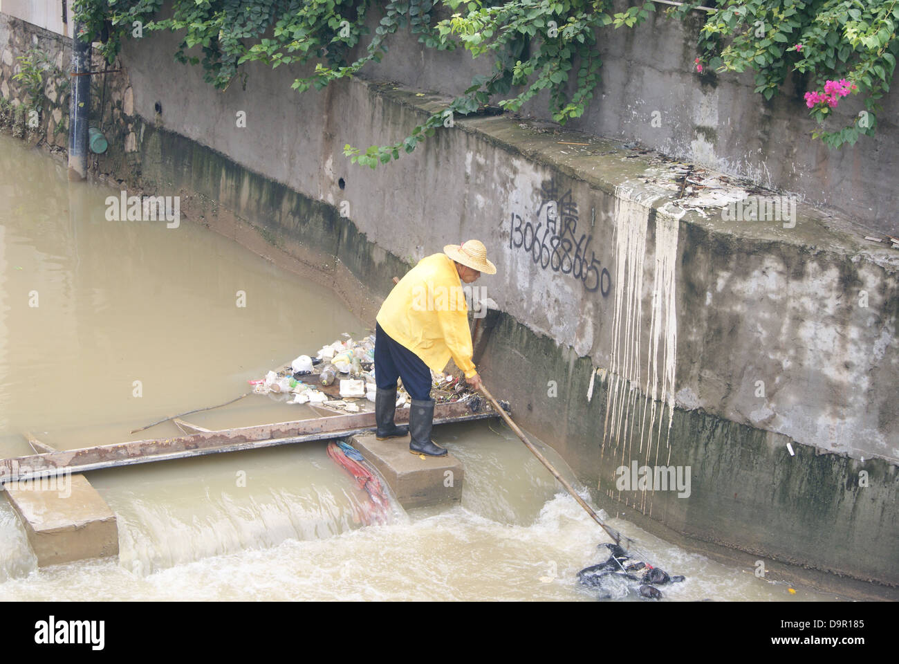 A worker in dredging river in Shenzhen, China Stock Photo - Alamy