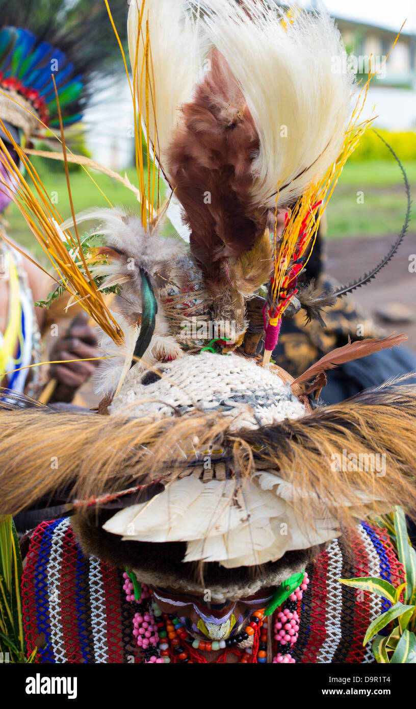 Woman leaning forward displaying her headdress at the Goroka Show in Papua New Guinea Stock Photo