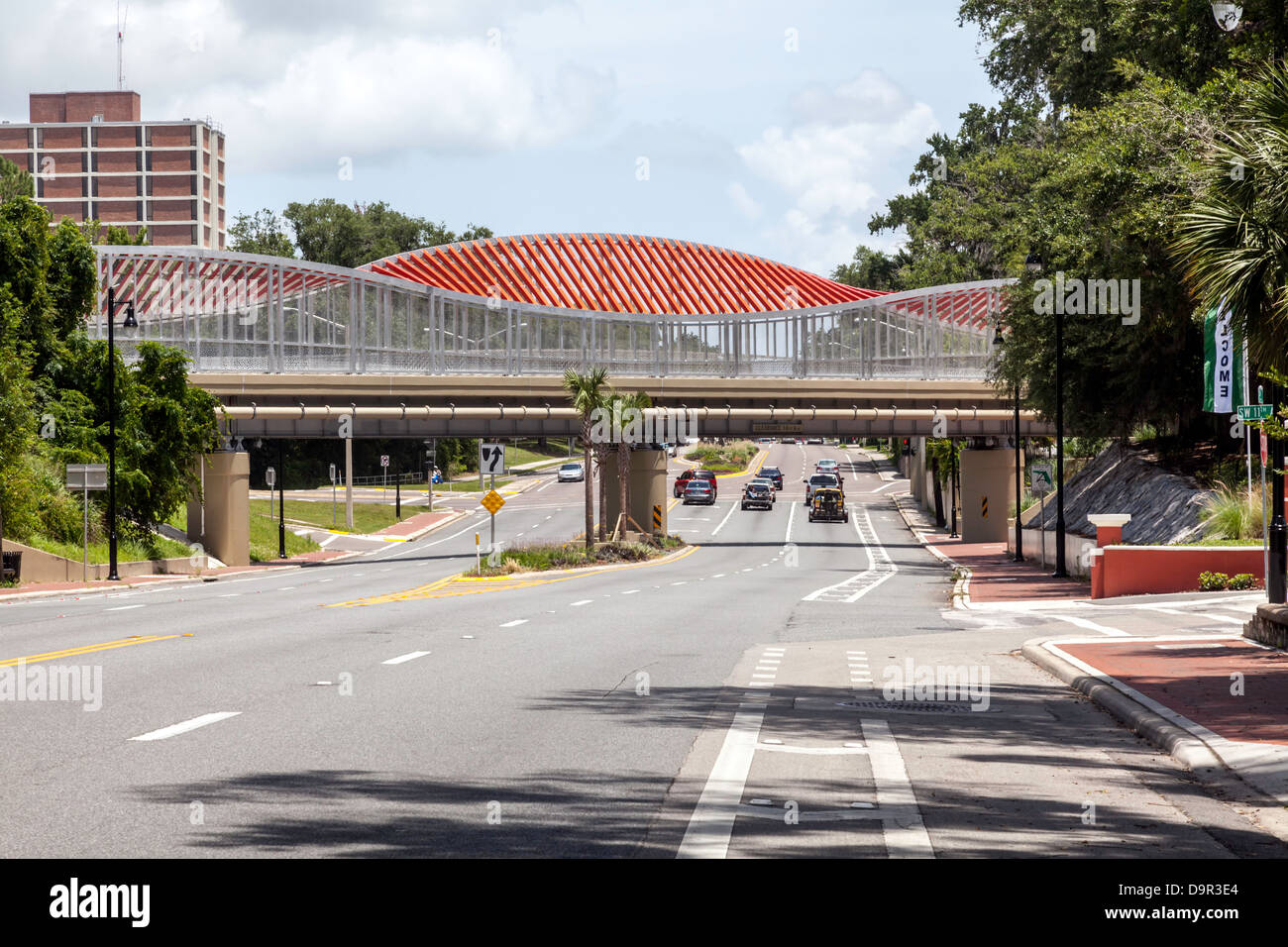 Orange pedestrian bridge across SW 13th Street at intersection with