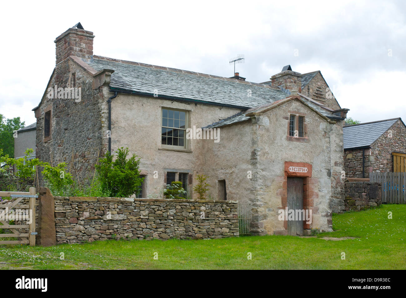 Old house with datestone (1714) in the village of Crosby Garrett, near Kirkby Stephen, Cumbria, England UK Stock Photo
