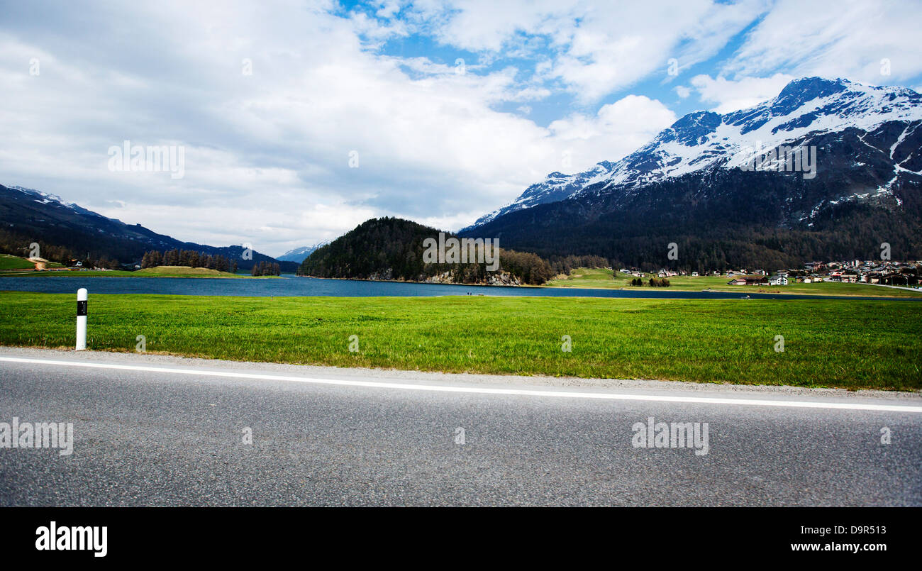 Road with mountains in background in a valley, St. Moritz, Italy Stock Photo