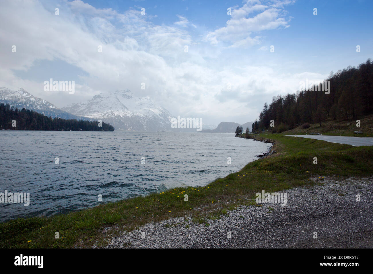 Lake with snow covered mountains in background in a valley, St. Moritz, Italy Stock Photo