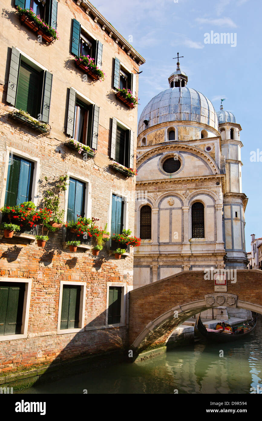 Bridge over a canal with a church in the background, Venice, Veneto, Italy Stock Photo