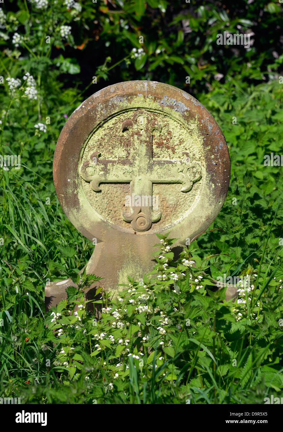 Circular gravestone with cross. Church of Saint Margaret. Stoven, Suffolk, England, United Kingdom, Europe. Stock Photo