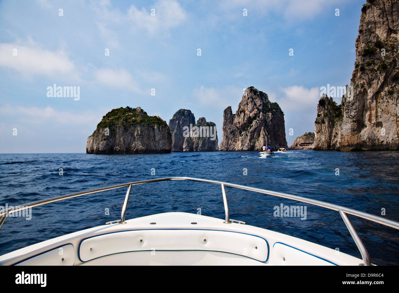 Boat in the sea with cliffs in the background, Capri, Naples Province, Campania, Italy Stock Photo