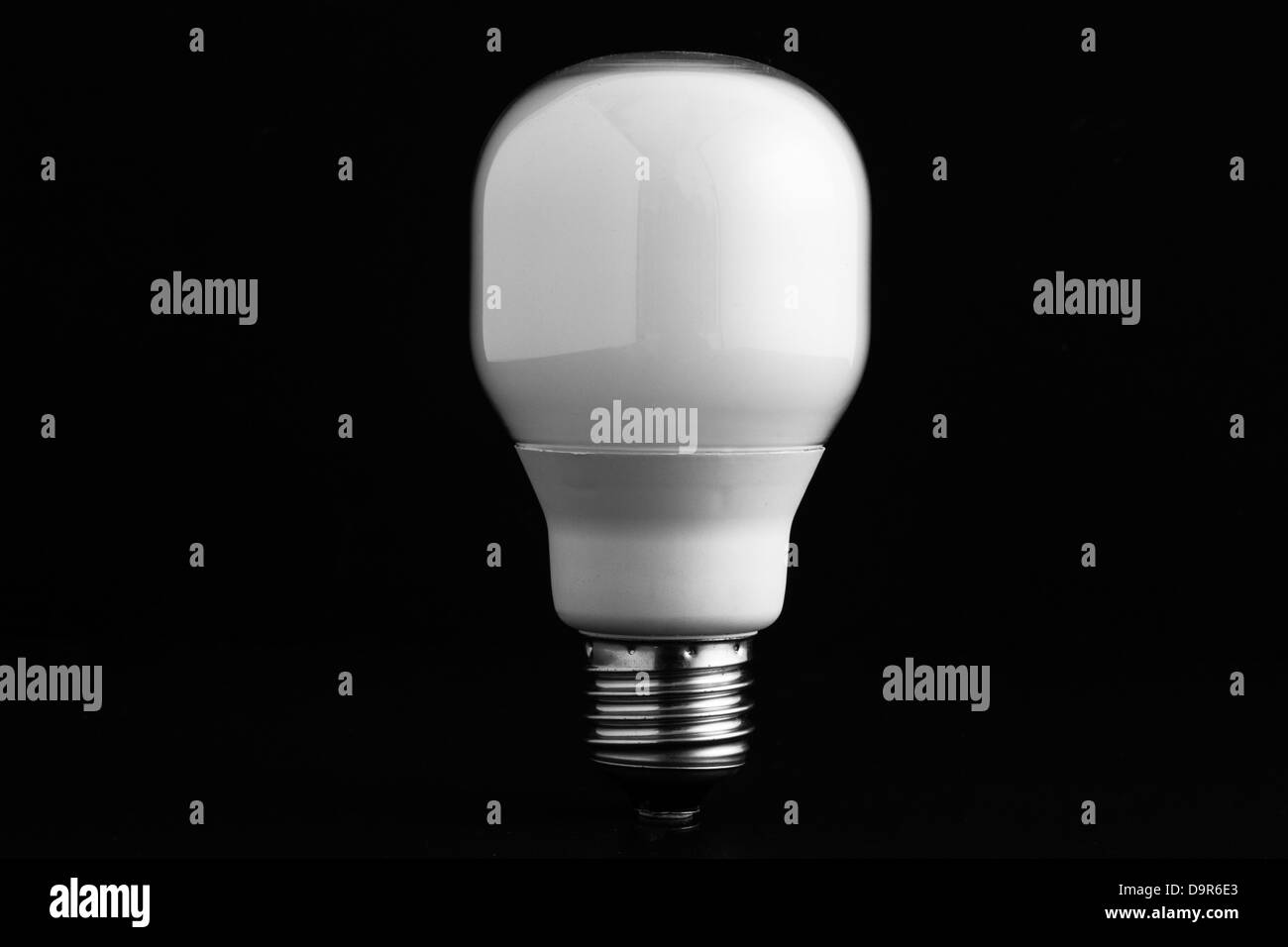 Energy saving bulb on black background Stock Photo