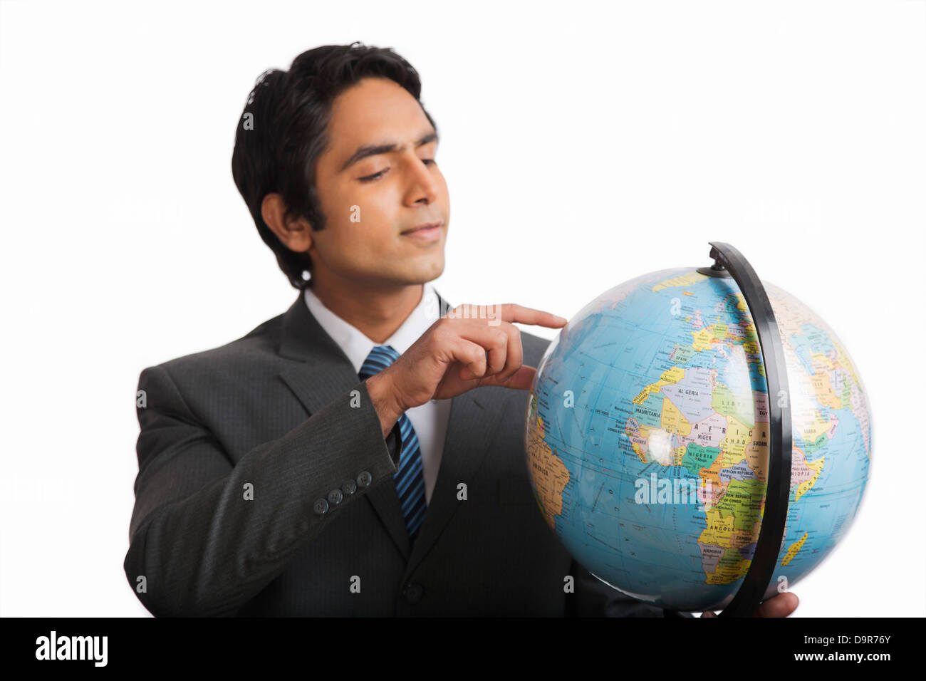 Businessman looking at a globe Stock Photo - Alamy