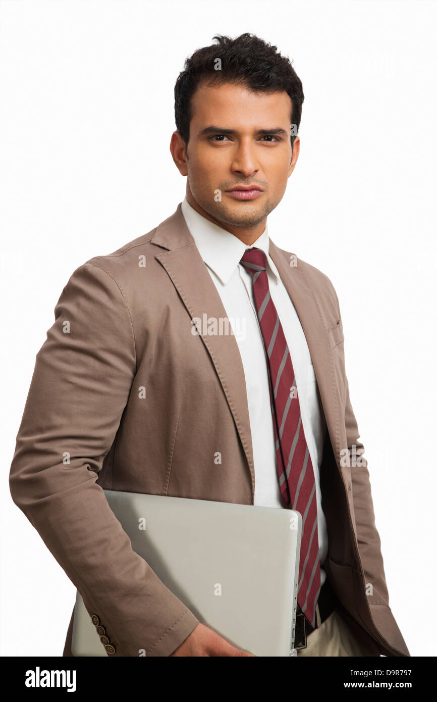 Portrait of a businessman holding a laptop Stock Photo