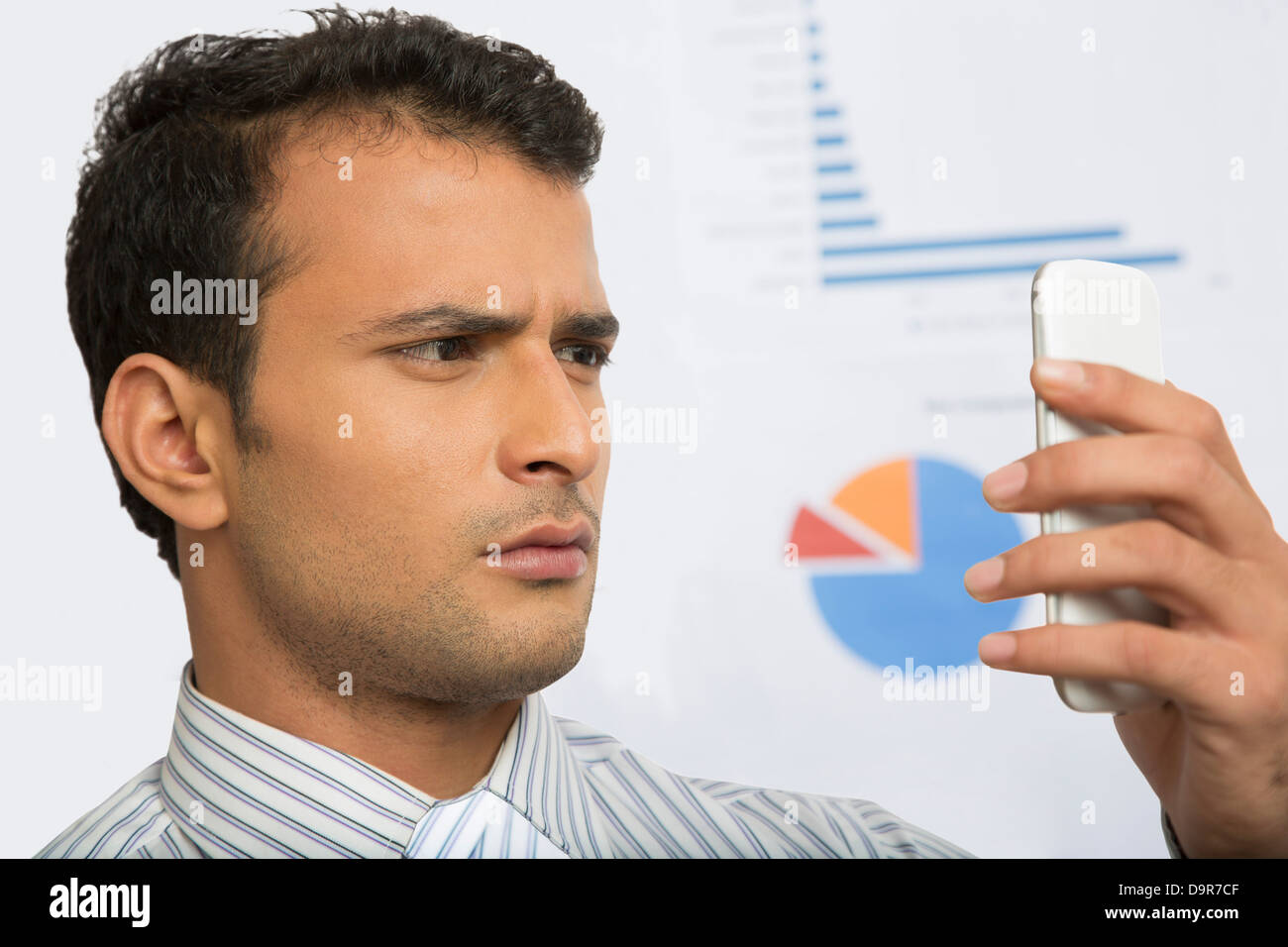 Businessman looking at a mobile phone Stock Photo