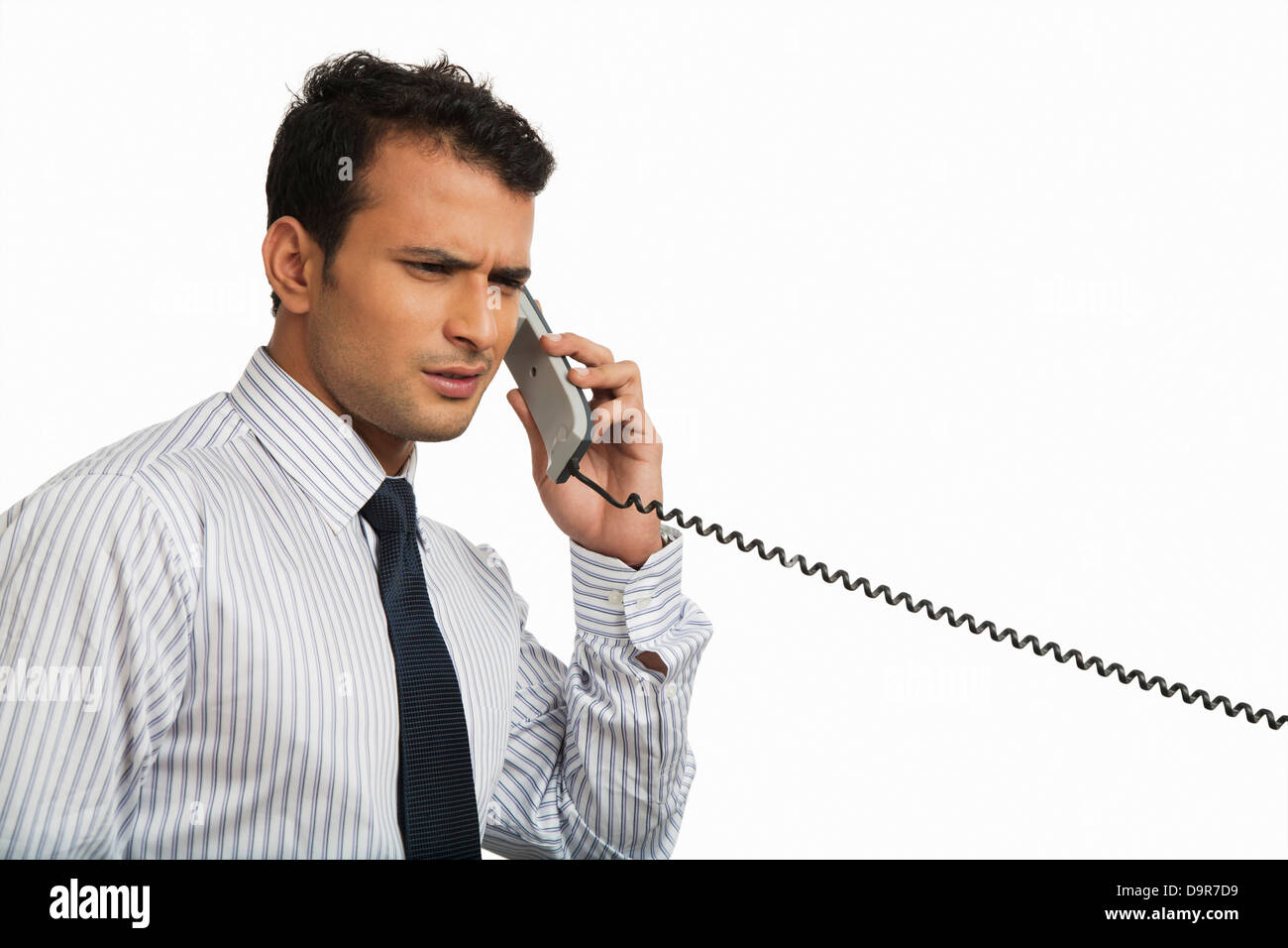 Businessman talking on a landline phone Stock Photo