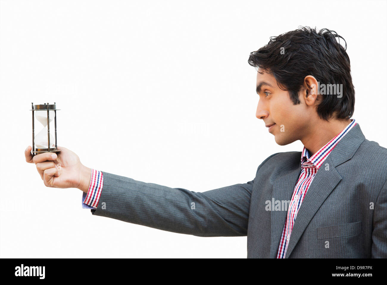 Businessman looking at an hourglass Stock Photo