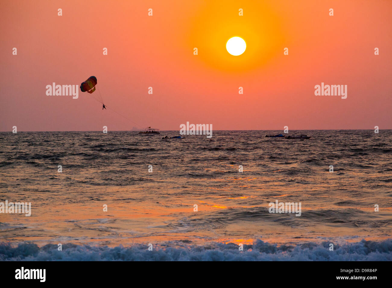 Silhouette of a person parasailing over the sea, Panjim, Goa, India Stock Photo