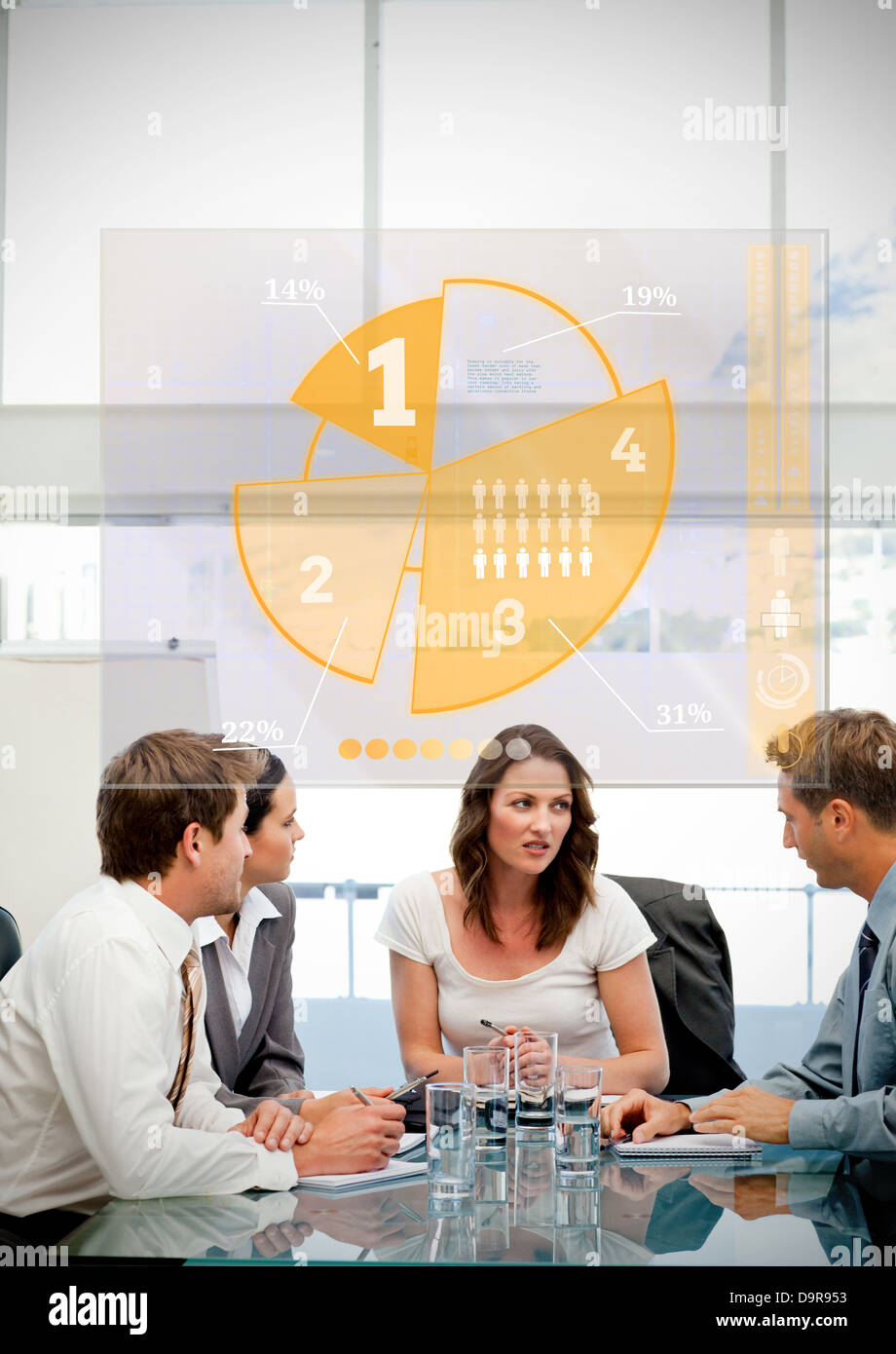 Business workers using yellow pie chart interface Stock Photo