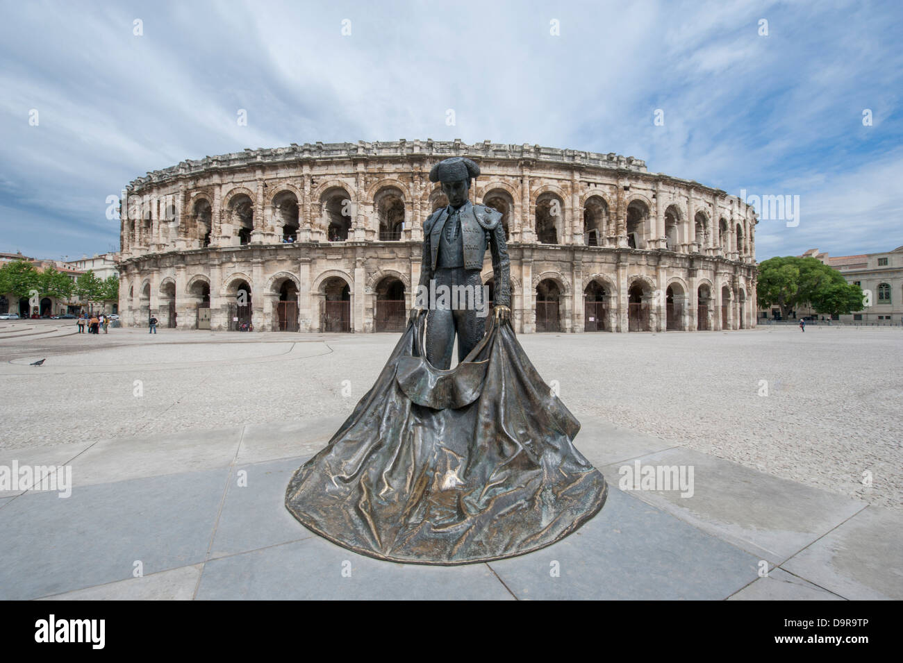 Statue of the famous bull-fighter Nimeño in front of Les Arénes, the roman amphitheatre in Nîmes, Languedoc, France Stock Photo