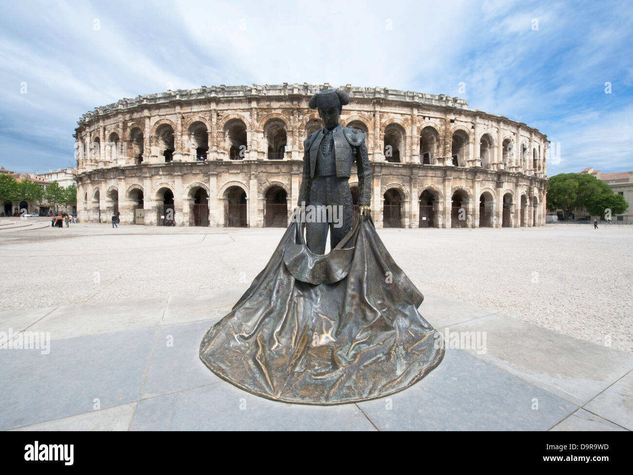 Statue of the famous bull-fighter Nimeño in front of Les Arénes, the roman amphitheatre in Nîmes, Languedoc, France Stock Photo