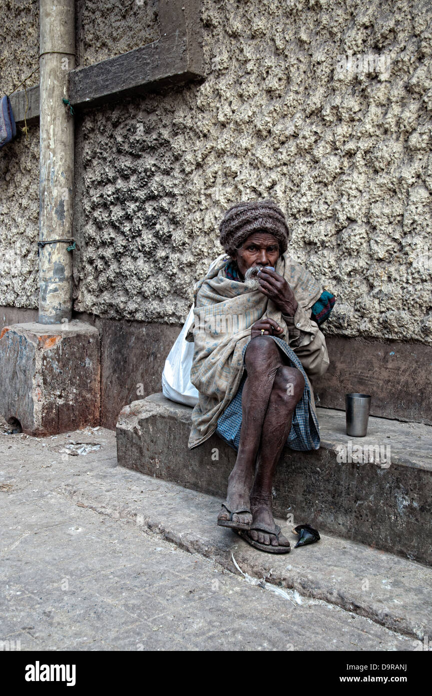 Portrait of a man taking medicine in the streets of Calcutta. West Bengal, India Stock Photo