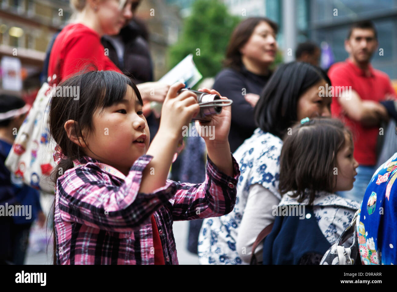 Young Japanese girl with camera taking a photo Stock Photo