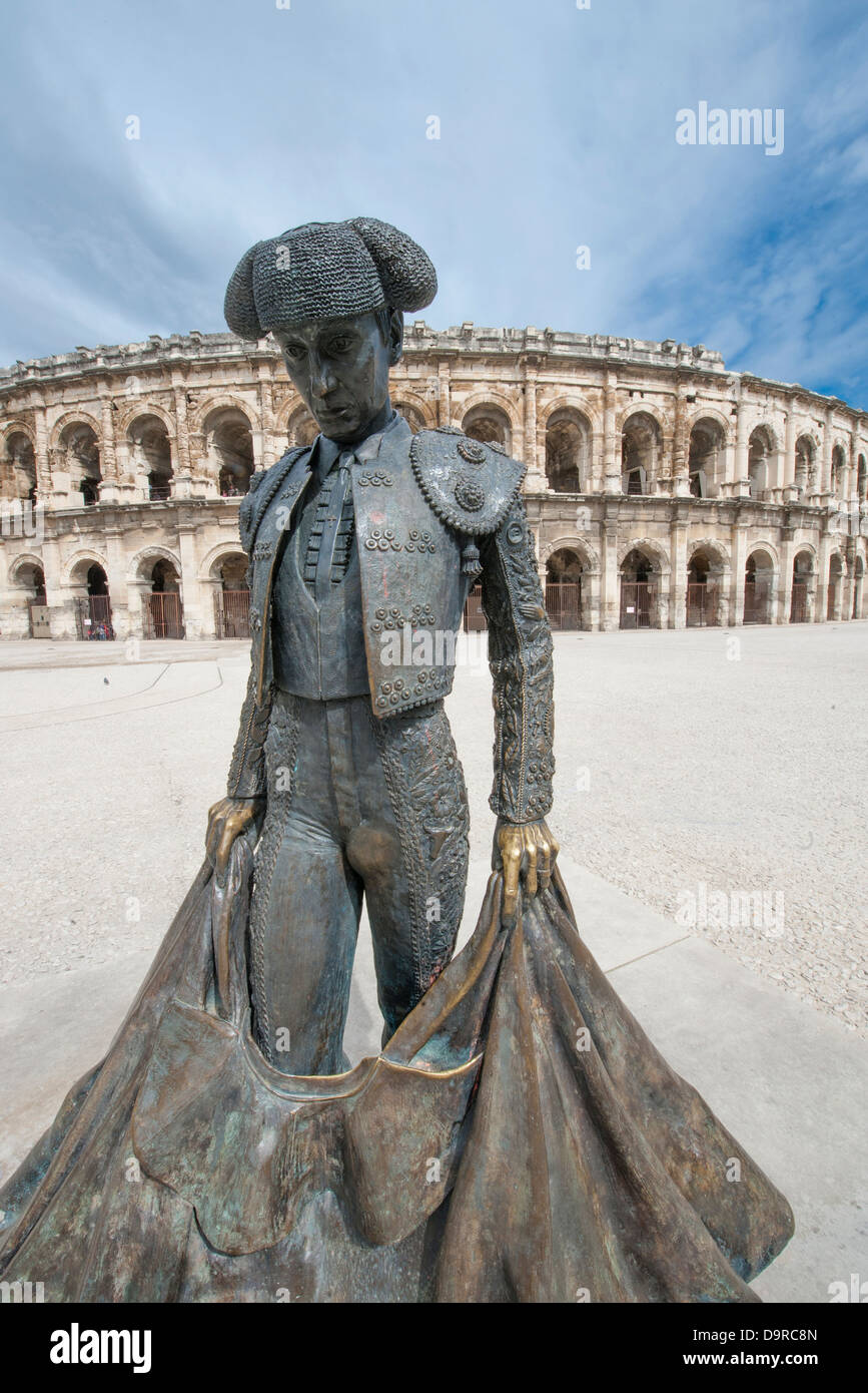 Statue of the famous bull-fighter Nimeño in front of Les Arénes, the roman amphitheatre in Nîmes, Languedoc, France Stock Photo