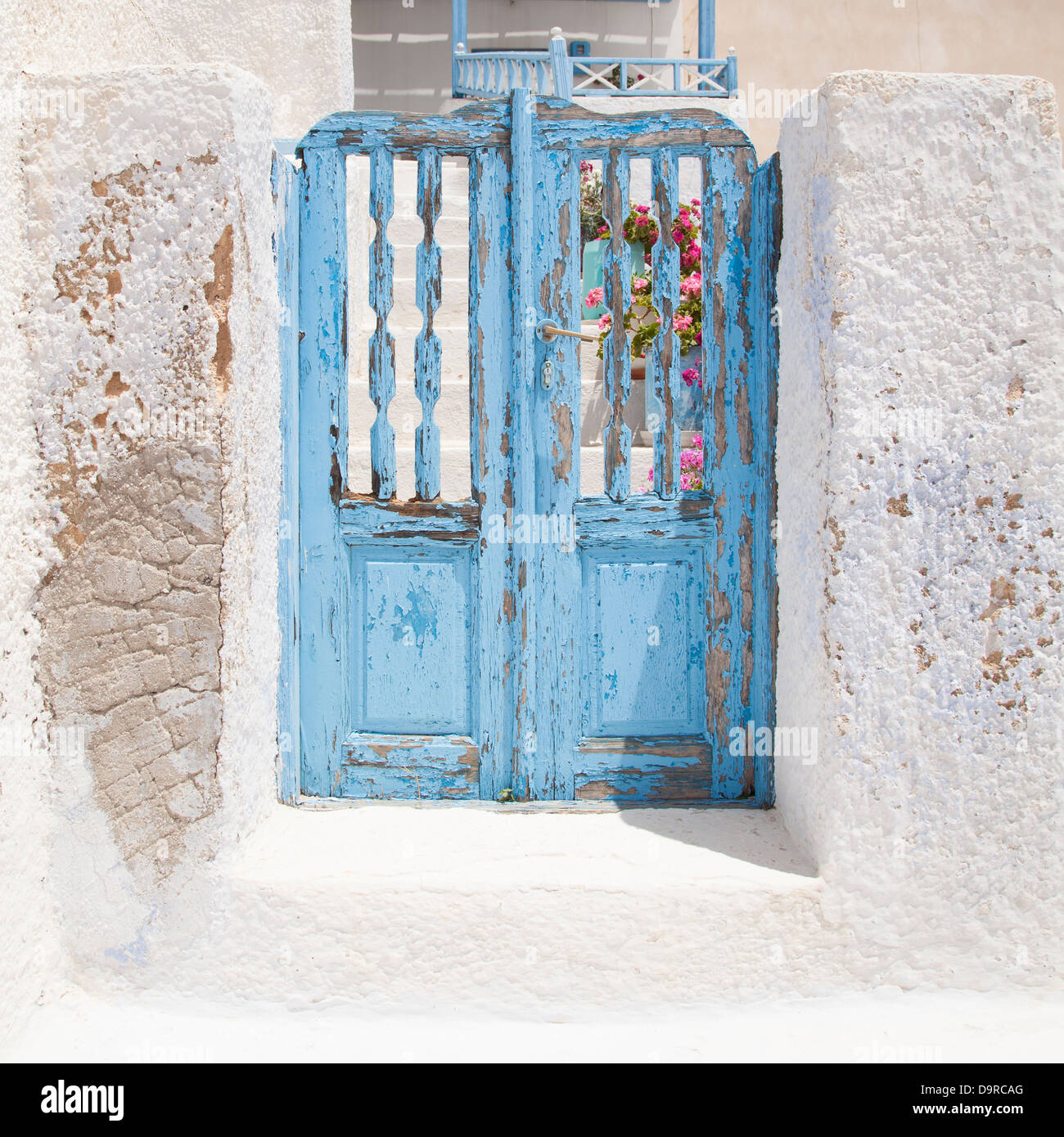 A blue gate stands as entrance to a house in Pyrgos, Santorini, Greece. Stock Photo
