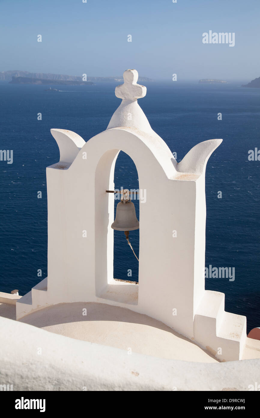A church bell on a rooftop in Oia looking out to sea on Santorini in Greece. Stock Photo