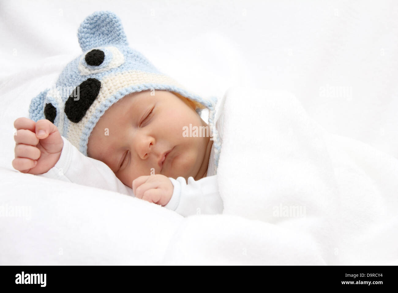 Sleeping baby with knitted hat Stock Photo