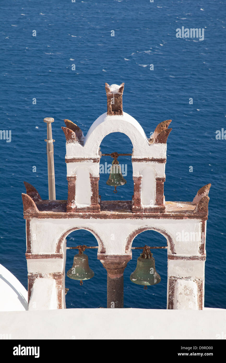 A church bell on a rooftop in Oia looking out to sea on Santorini in Greece. Stock Photo