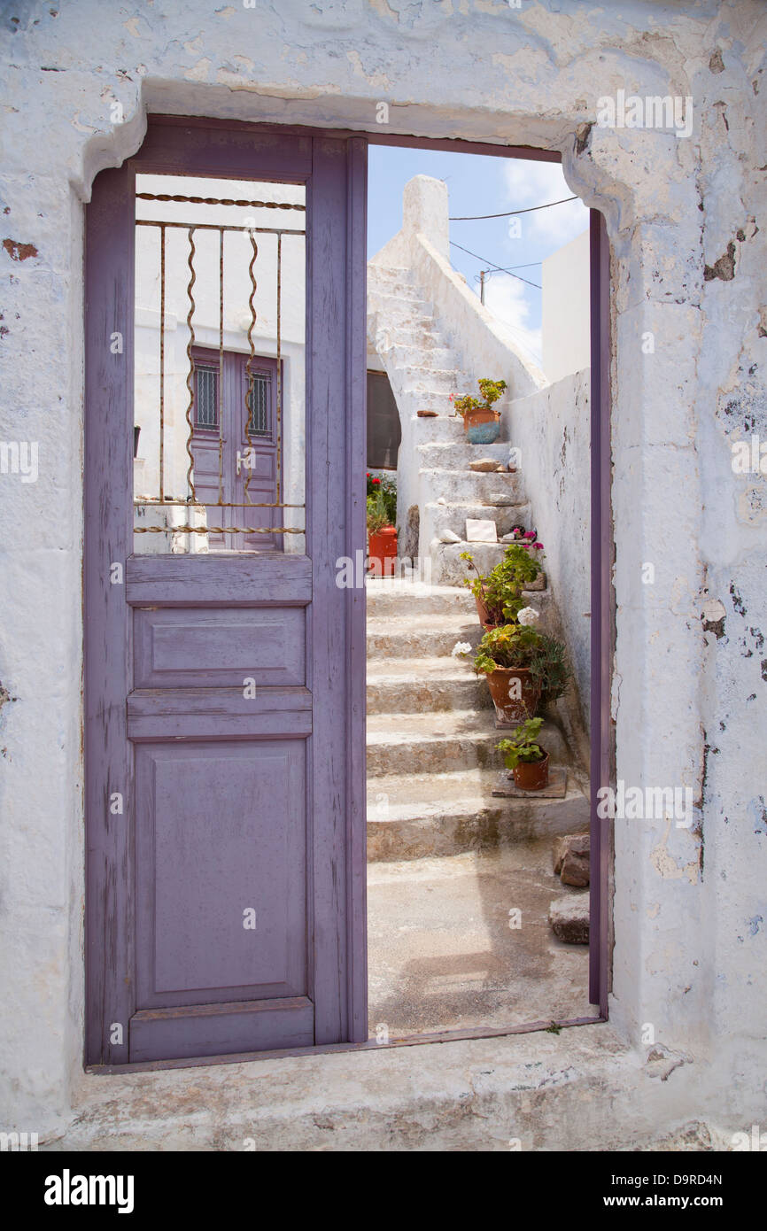 A purple door leads to a courtyard in the pretty town of Pyrgos, Santorini, Greece. Stock Photo