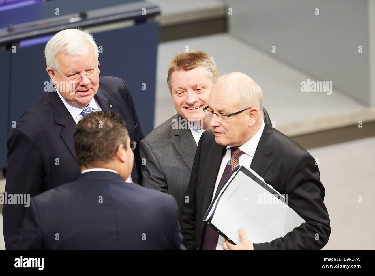 Berlin, Germany. 25th  June, 2013. The Bundestag is holding a special session on 'Helping the victims of the flood misery'. German Chancellor Angela Merkel is giving a government statement on the aids for the vitims of the flood misery providing immediate help and reconstruction. Picture: Volker Krauder, Chairman of the CDU, Hermman Gröhe, CDU General Secretary, and Patrick Doering (FDP), FDP General Secretary, pictured together at the Special session of the Bundestag on 'Helping the flood victims' at Bundestag in Berlin Credit:  Reynaldo Chaib Paganelli/Alamy Live News Stock Photo