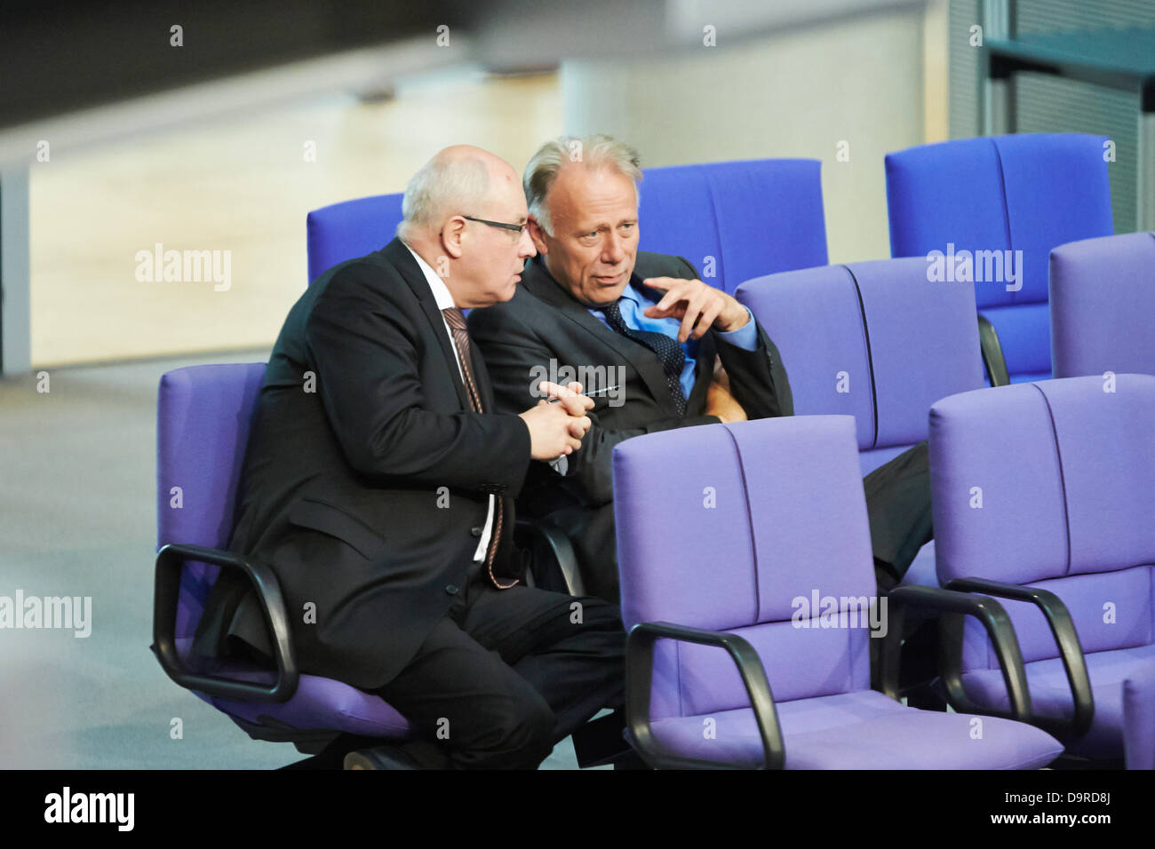 Berlin, Germany. 25th  June, 2013. The Bundestag is holding a special session on 'Helping the victims of the flood misery'. German Chancellor Angela Merkel is giving a government statement on the aids for the vitims of the flood misery providing immediate help and reconstruction. Picture: Juergen Trittin (Green), Chairman of the Green parliamentary group, and Volker Krauder, Chairman of the CDU, talking at the Bundestag. Credit:  Reynaldo Chaib Paganelli/Alamy Live News Stock Photo