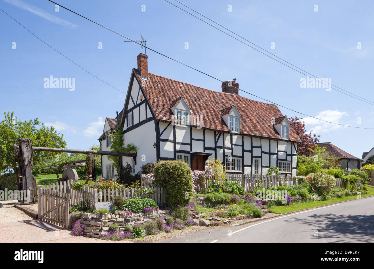 Timber framed cottage with telephone and power lines spoiling the view, Warwickshire, England, UK Stock Photo