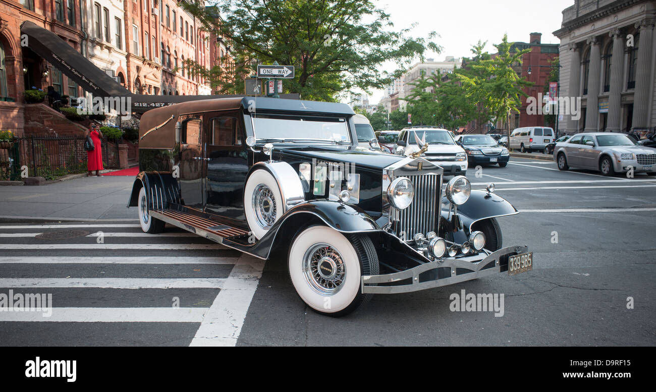 Isaiah Owens, the owner of Owens Funeral Home, in Harlem in New York driving his 1924 Rolls-Royce hearse in a procession Stock Photo