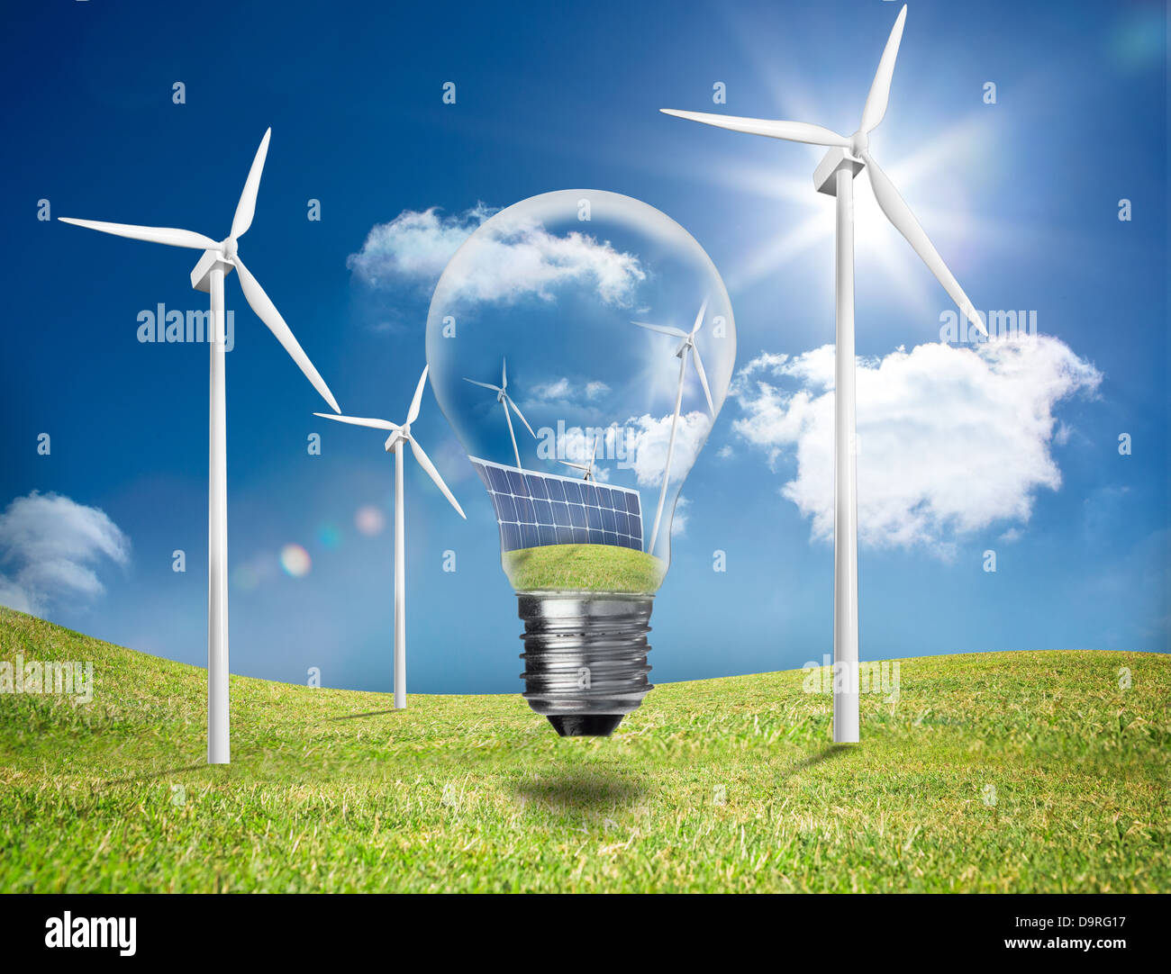 Light bulb showing solar panels and turbines in a field with wind