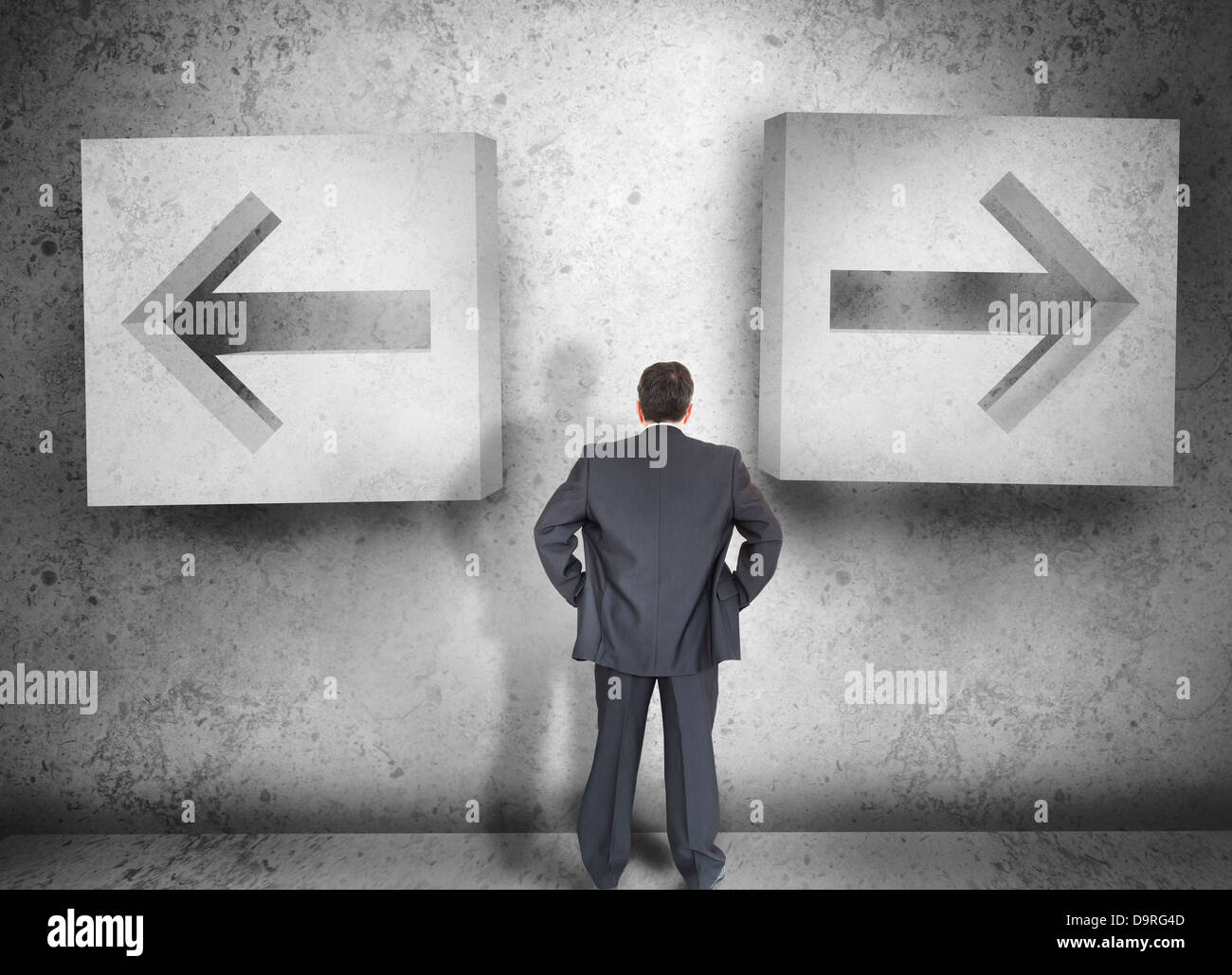 Businessman deciding which way to go Stock Photo