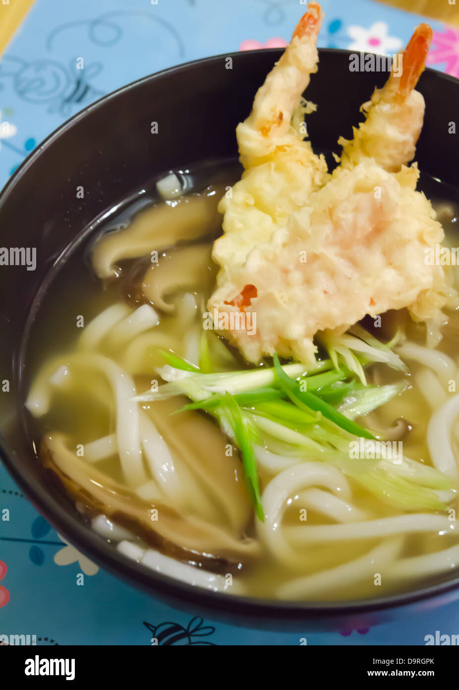 top views udon noodles with shrimp tempura in black bowl , Japanese food Stock Photo