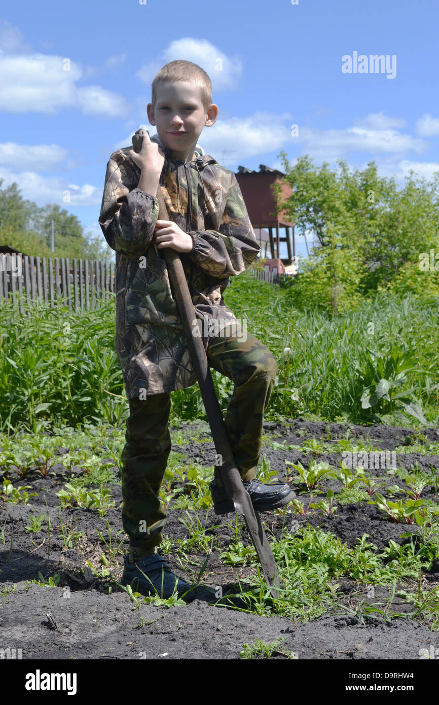 the teenager with a shovel in a garden Stock Photo - Alamy