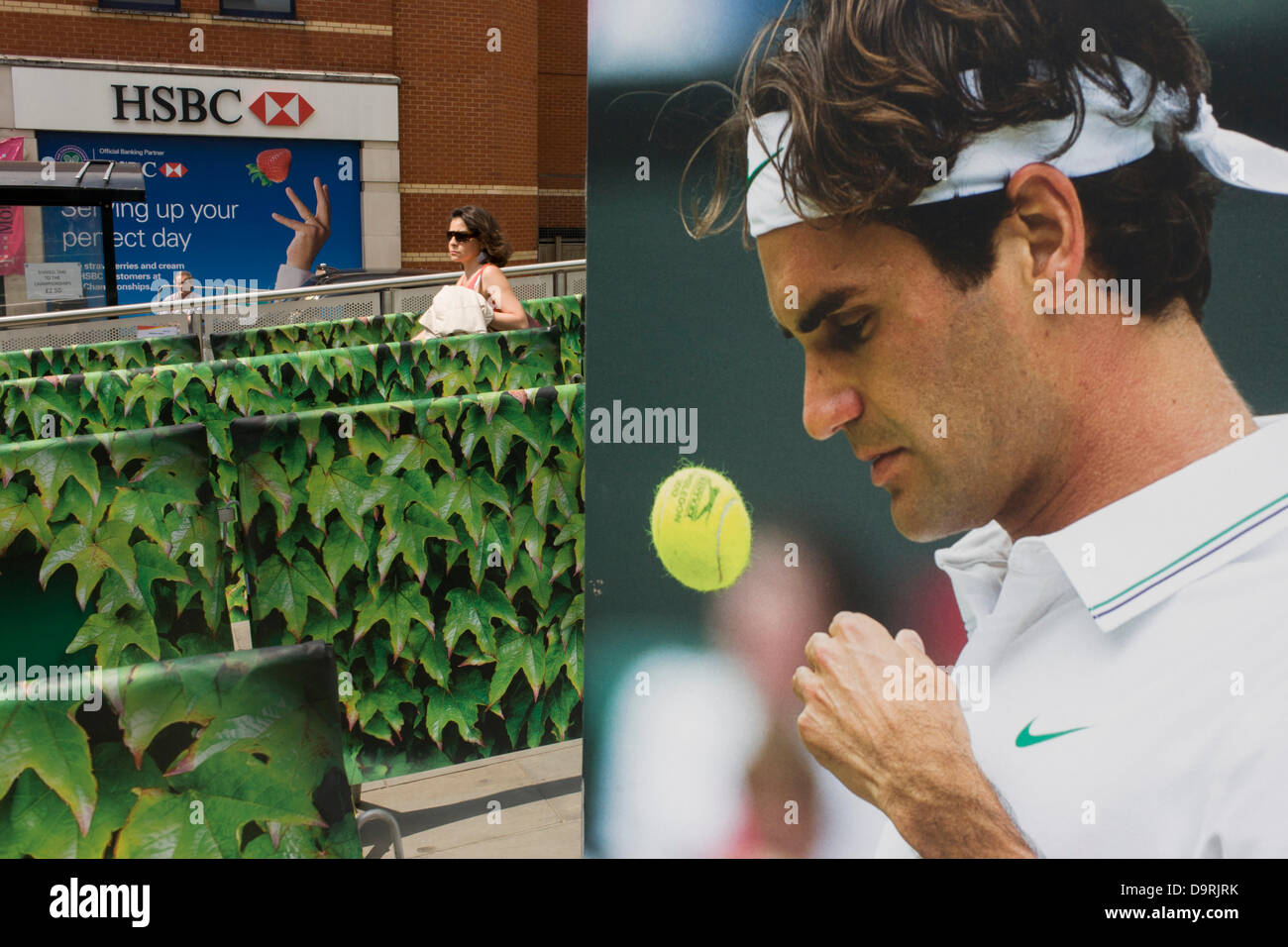 Wimbledon, England, 25th June 2013 - Day 2 of the annual lawn tennis championships and a poster of past Mens' champion Roger Federer outside the mainline and underground (subway) station in the south London suburb. The Wimbledon Championships, the oldest tennis tournament in the world, have been held at the nearby All England Club since 1877. Stock Photo