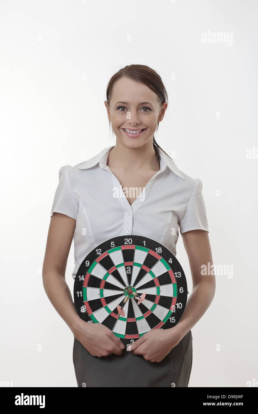 Businesswoman holding up a dart board  Stock Photo