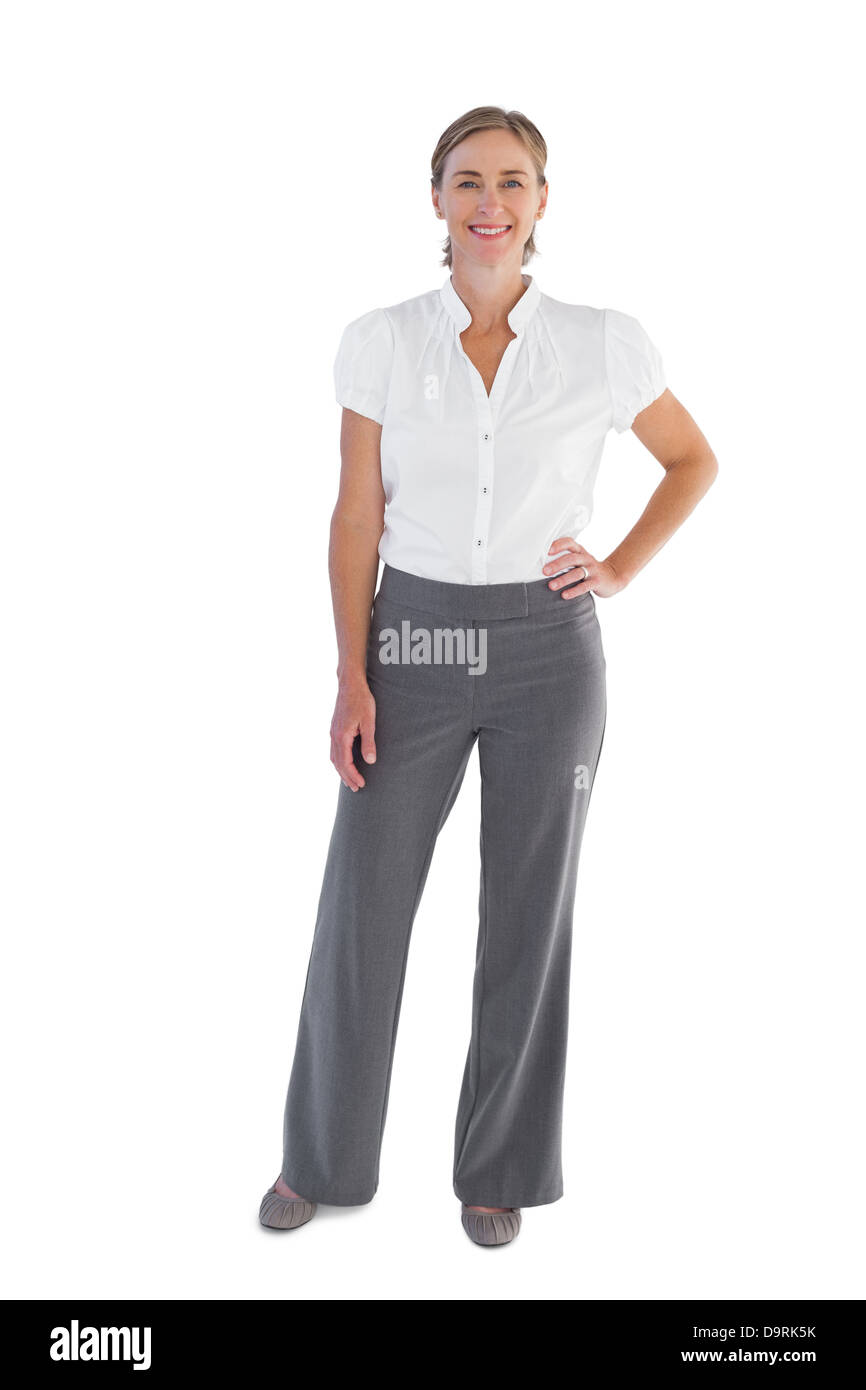 Smiling businesswoman standing with her hand on her hip Stock Photo - Alamy