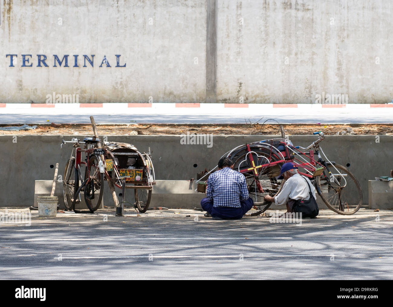 repair of tricycles in the street Stock Photo Alamy