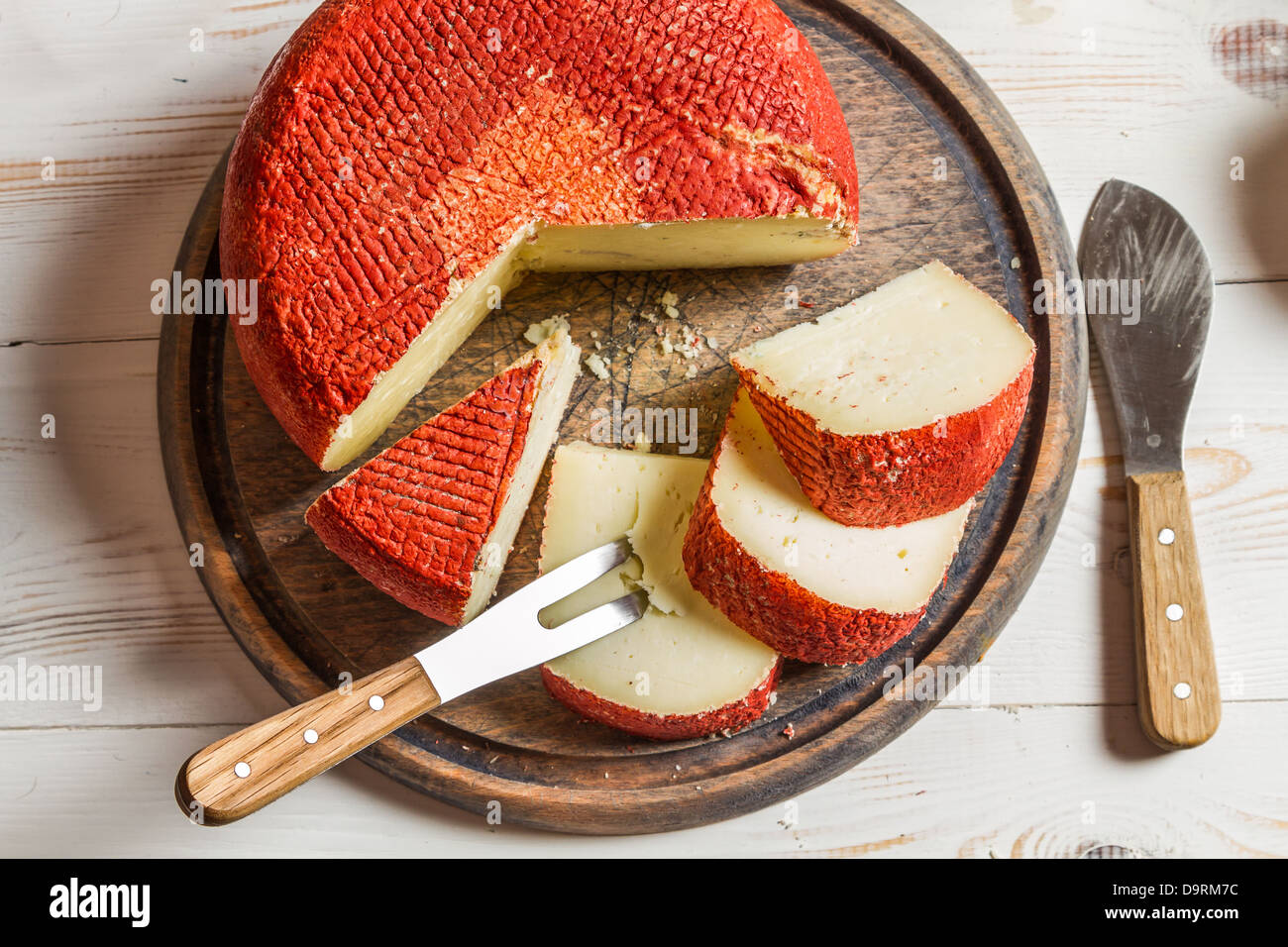 Yellow hard cheese with red wax Stock Photo