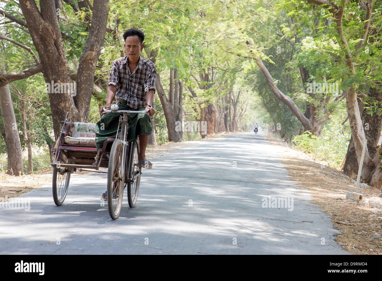 man rides a tricycle in an alley Stock Photo - Alamy