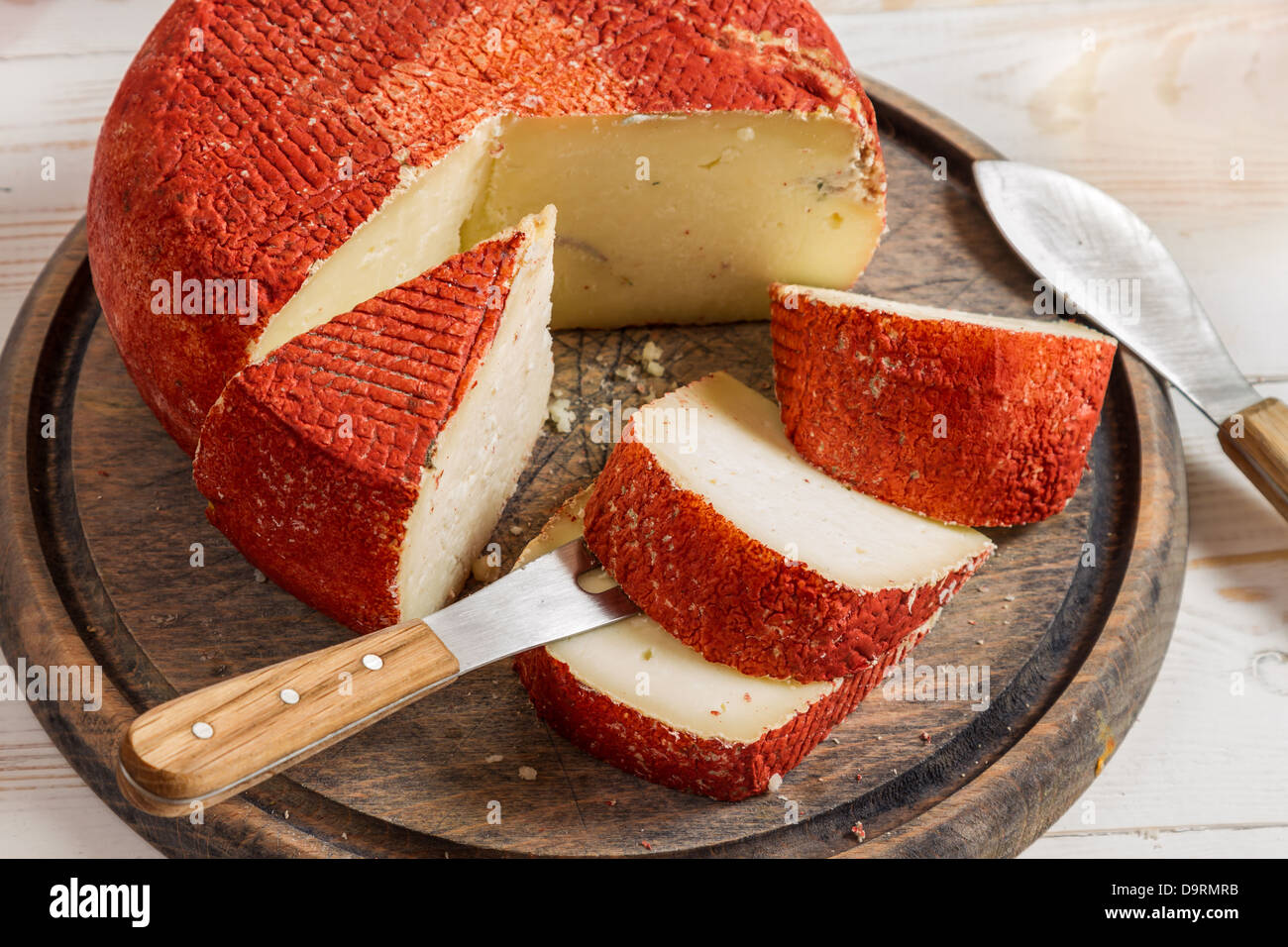 Closeup of yellow hard cheese with red wax Stock Photo