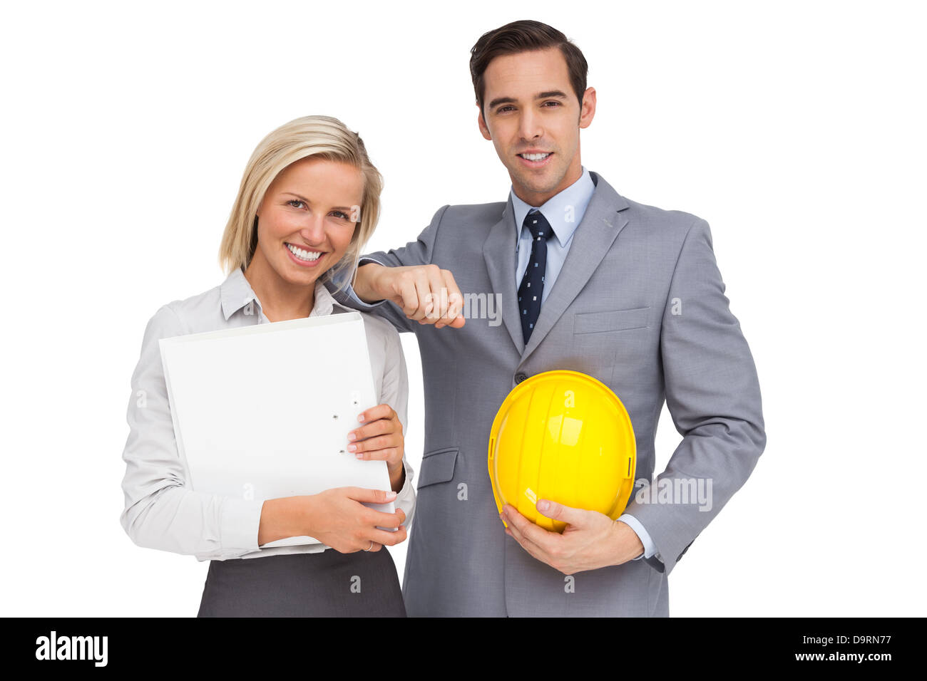 Architects with plans and hard hat Stock Photo