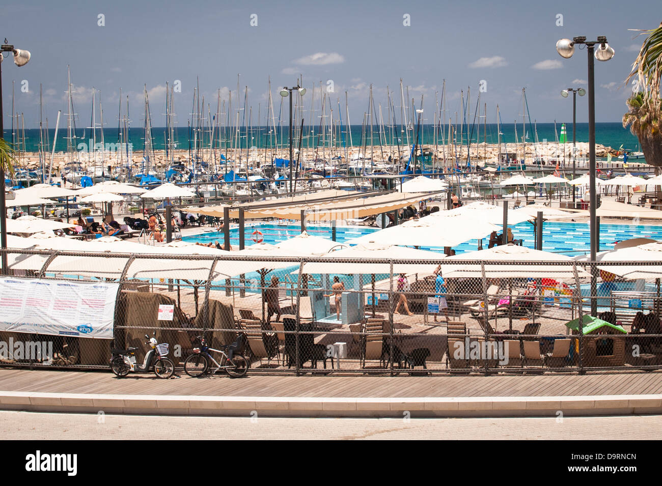 Israel Tel Aviv Gay Pride Day Gordon Beach swimming pool leisure pleasure boat port harbour marina Mediterranean Sea blue sky palm trees Stock Photo