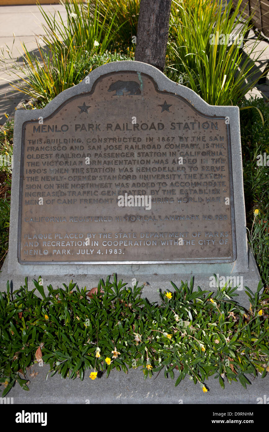 MENLO PARK RAILROAD STATION This building, constructed in 1867 by the San Francisco and San Jose Railroad Company, is the oldest railroad passenger station in California. The Victorian ornamentation was added in the 1890s when the station was remodeled to serve the newly-opened Stanford University. The extension on the northwest was added to accommodate increased traffic generated by the establishment of Camp Fremont nearby during World War I. Plaque placed by the State Department of Parks & Recreation in cooperation with the City of Menlo Park. July 4, 1983. Stock Photo